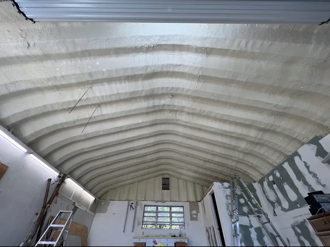 Spray polyurethane foam applied to the underside of a metal roof deck in Auburn